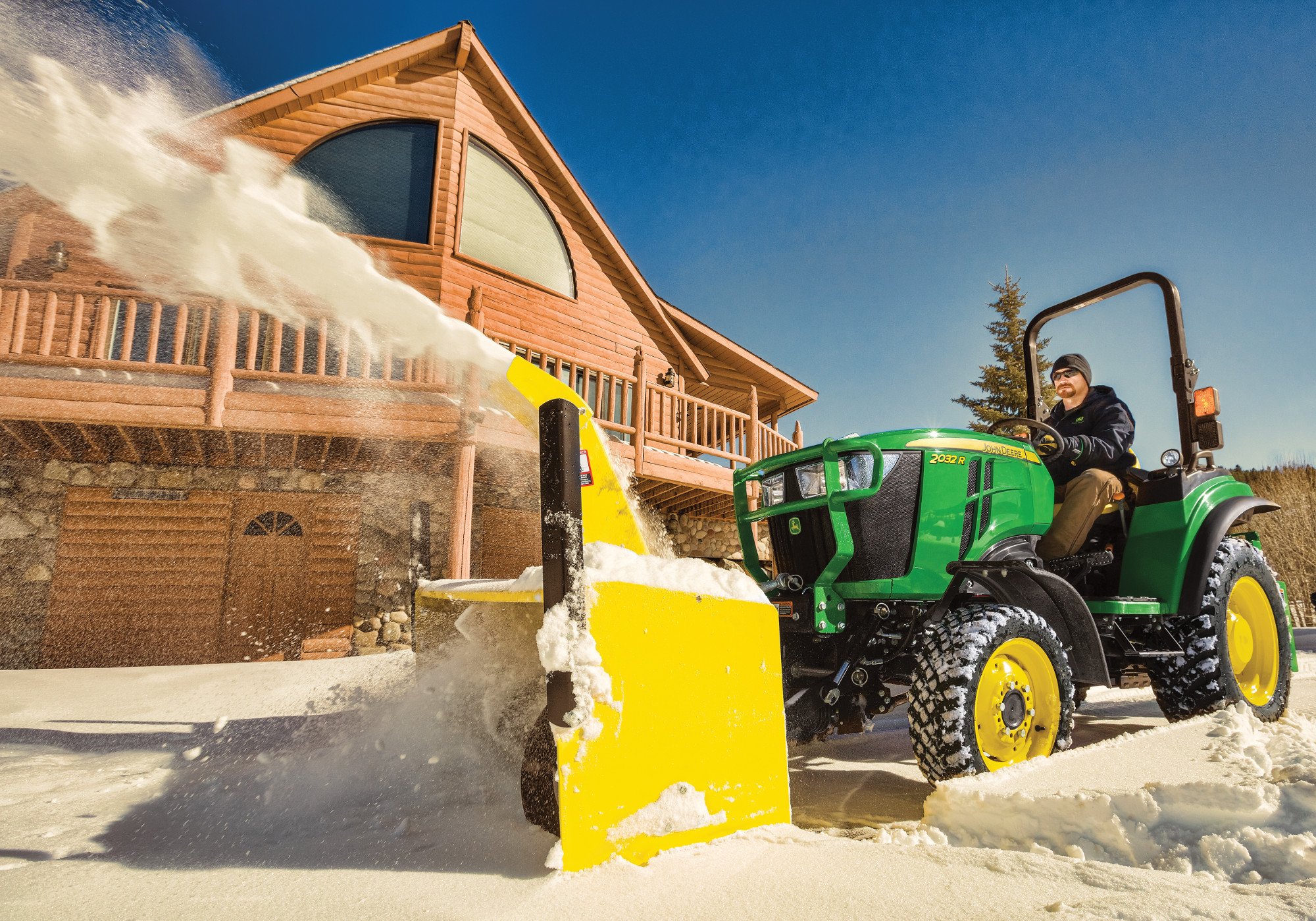 John Deere 2 Series with front mounted snow blower