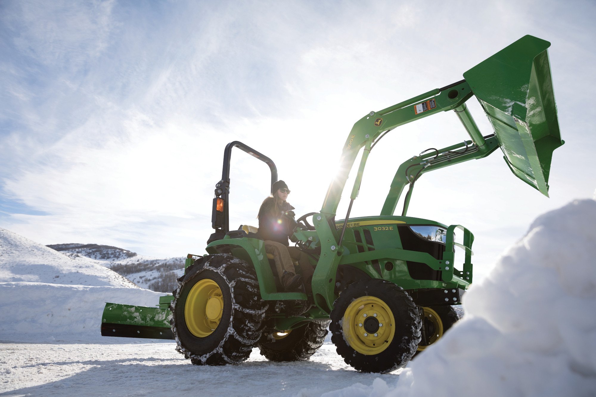 John Deere 3E Compact Tractor moving snow with loader